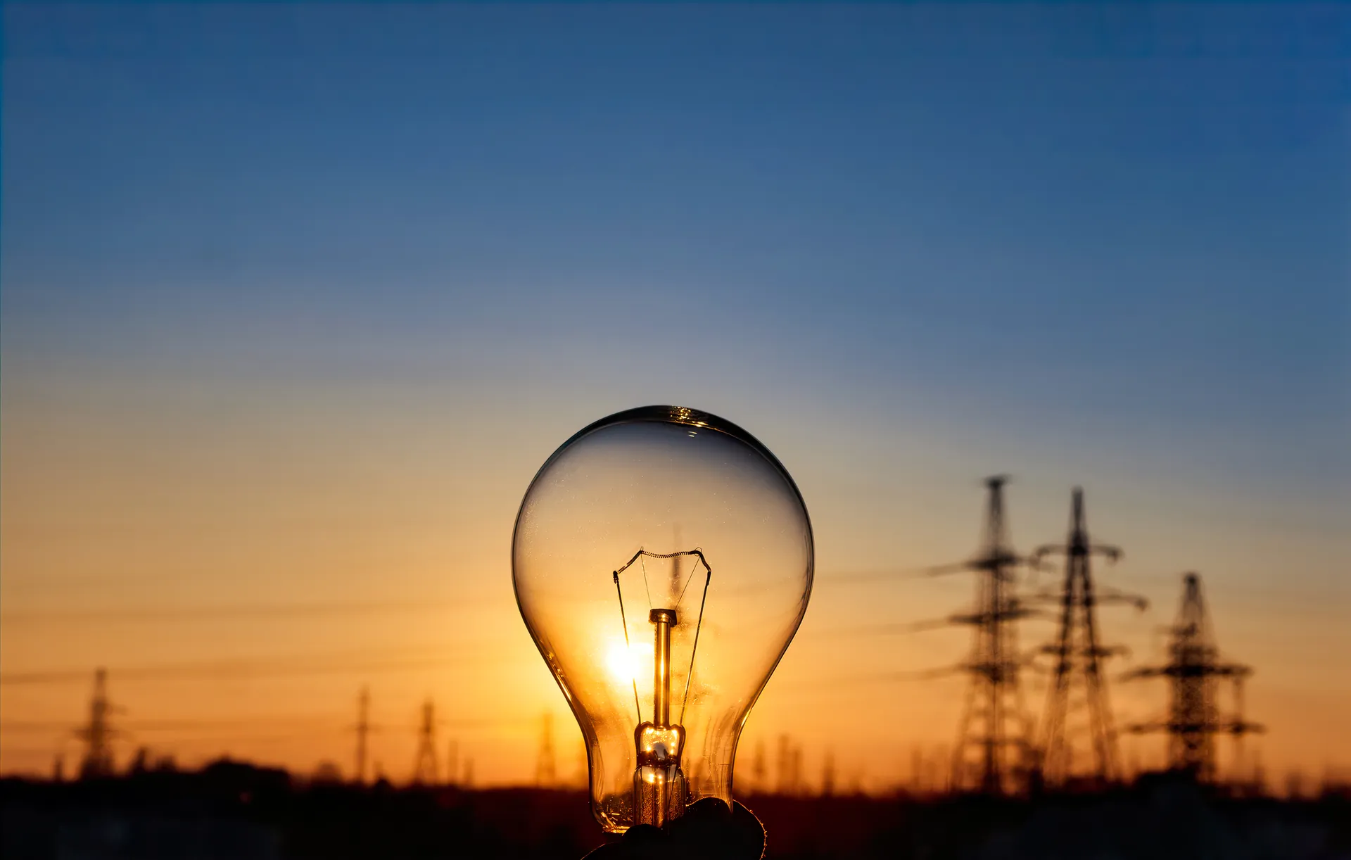 light-bulb-with-high-voltage-line-background-electricity-energy-savings-city